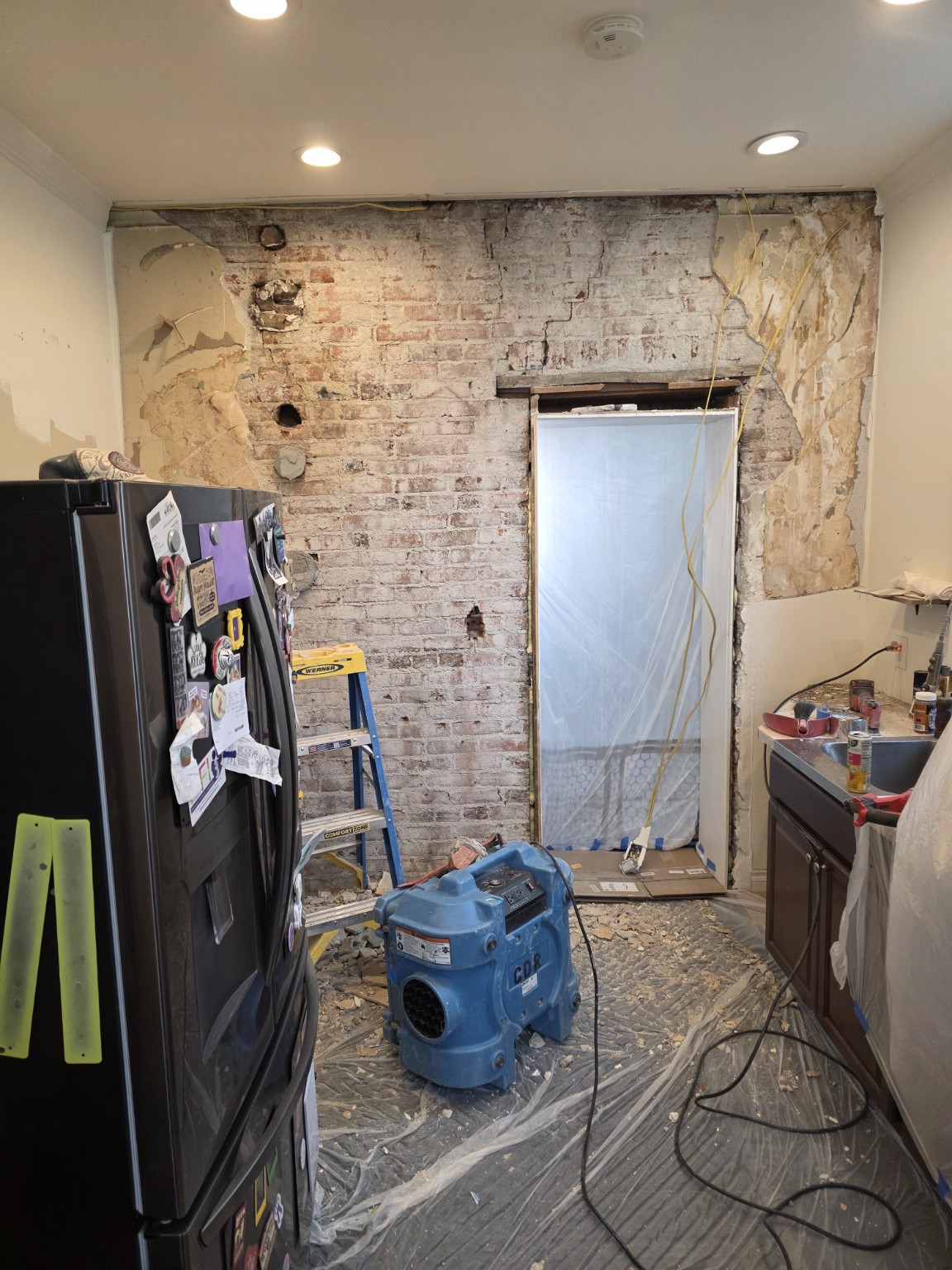 Existing load-bearing brick wall before structural opening work
