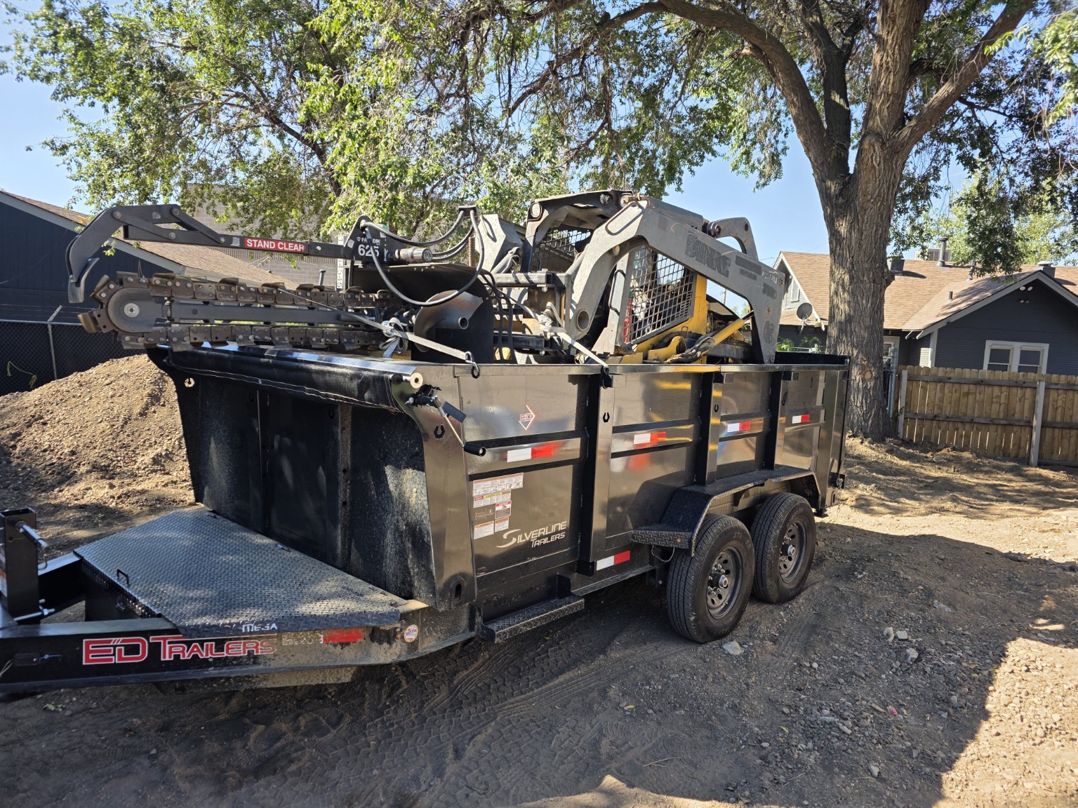 New Beginnings skid steer and attachments loaded for site work