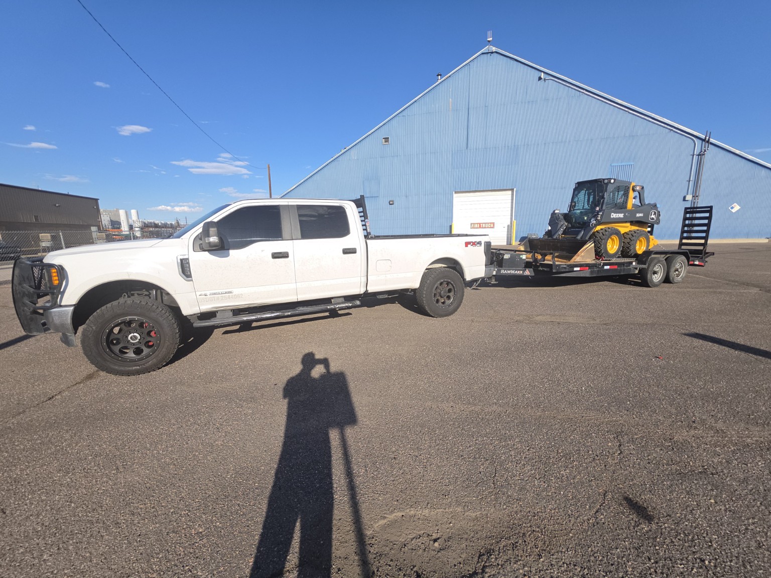 New Beginnings truck and skid steer ready for transport